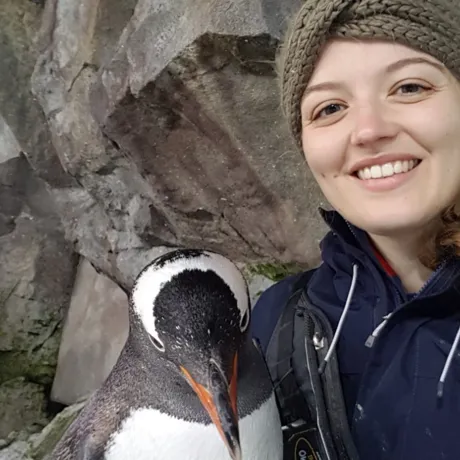Jess smiling with her penguin friend