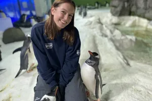 Kiara smiling with her penguin friends