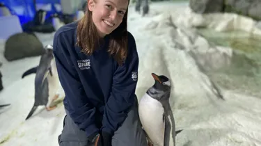Kiara smiling with her penguin friends