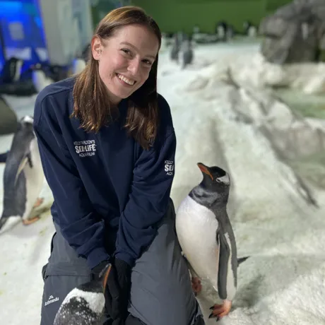 Kiara smiling with her penguin friends