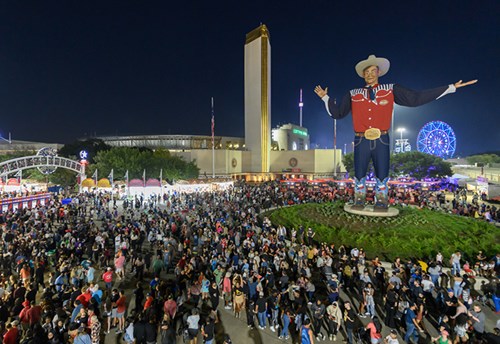 Visitors walking around the 55-foot tall Big Tex at the Texas State Fair