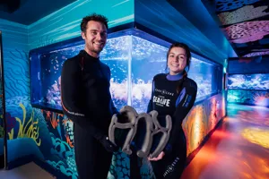 Two Aquarists holding a 3D-Moulded Coral Structure