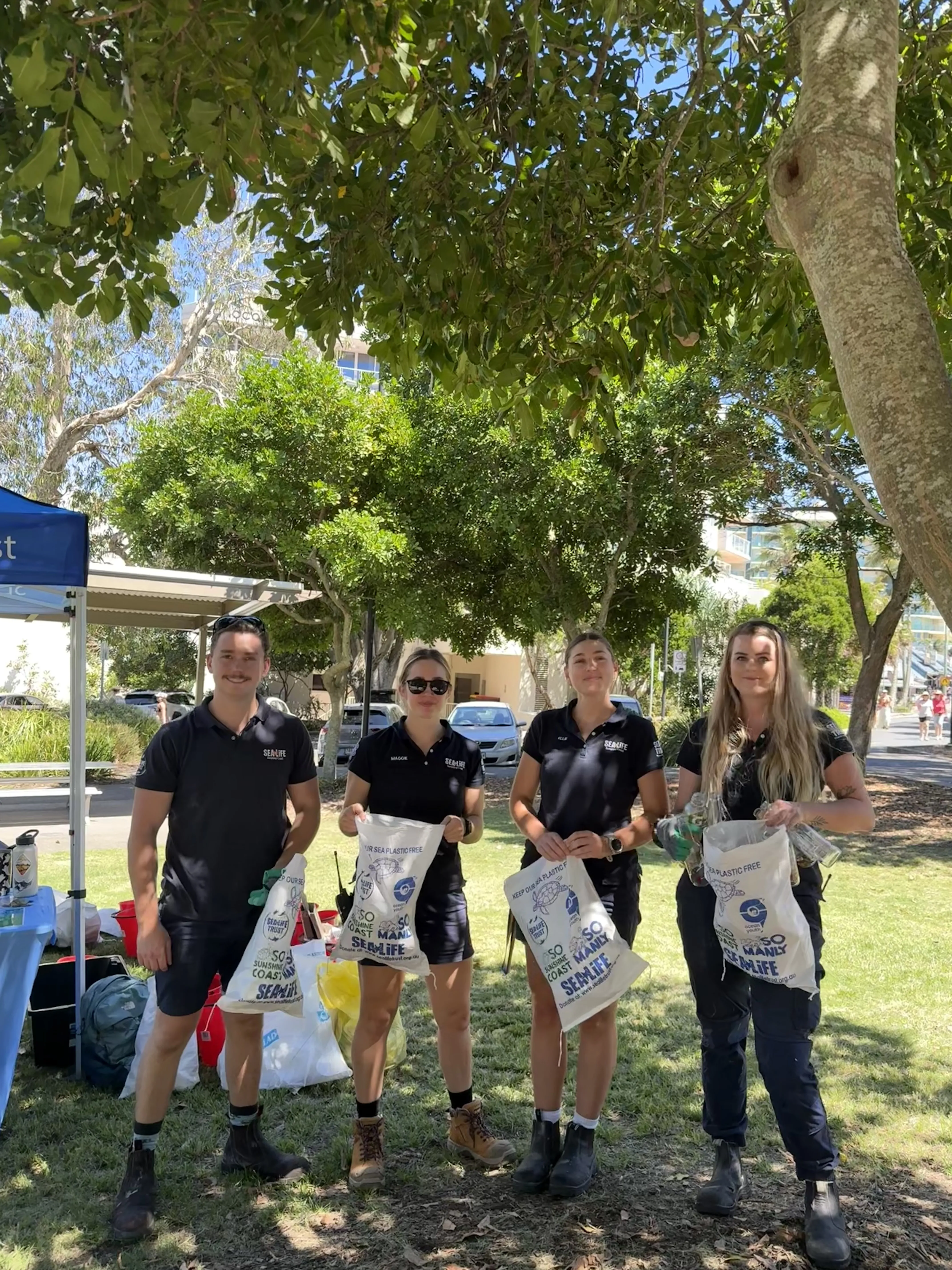 team holding rubbish bags