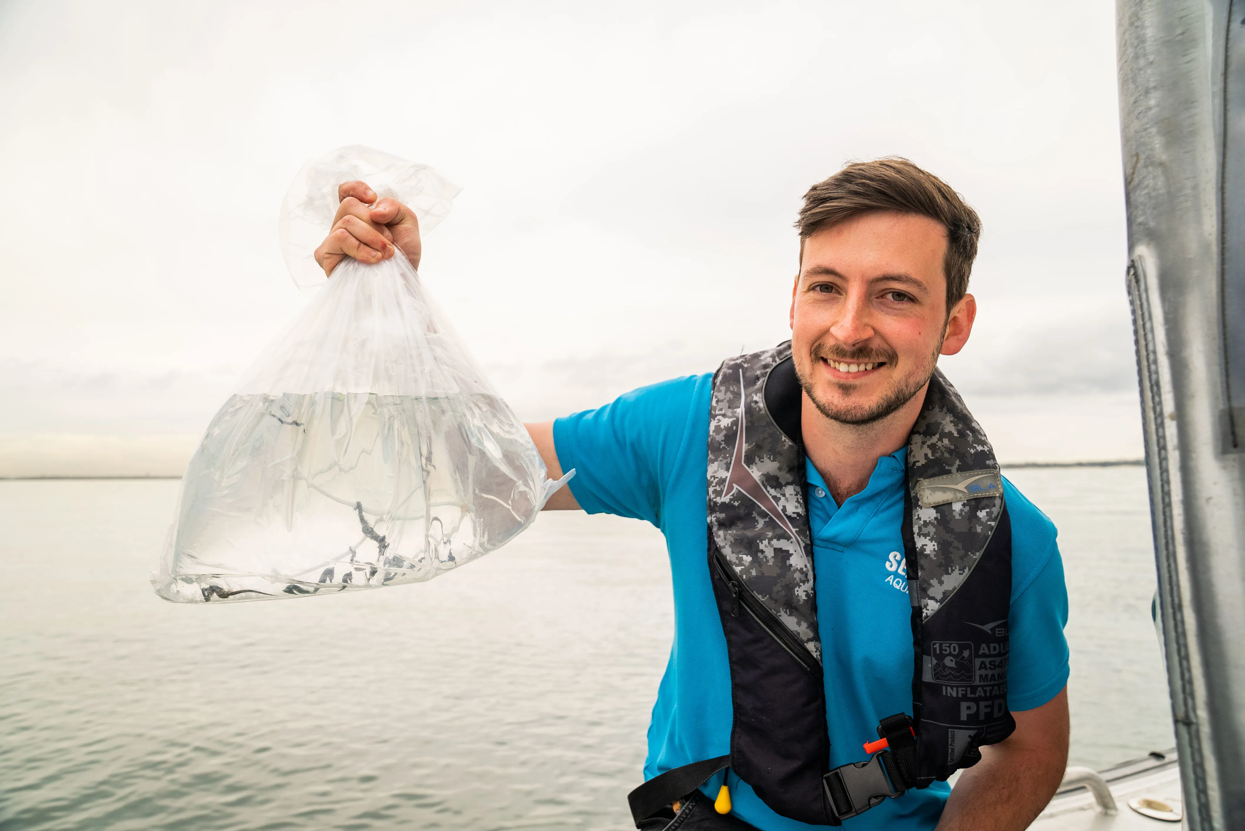 SEA LIFE Sydney Aquarium Supervisor Daniel Sokolnikoff With Transport Bag Containing Several Captive Bred White's Seahorse Ahead Of Release