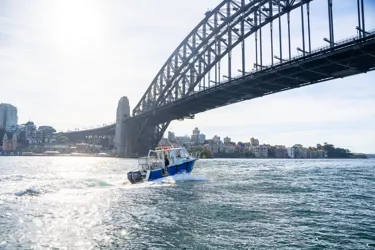 Boat Going Under The Harbour Bridge In Sydney
