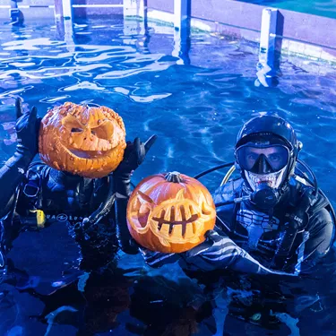 Divers (L To R Mitch Thornton & Tom Burd) Prepare To Dive With Pumpkins